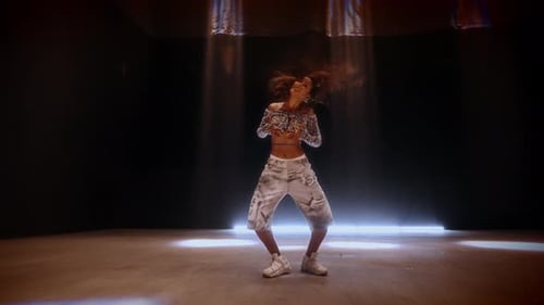 Solo Dancer's Intense Movements Under Matrix Beam Lights In A Studio