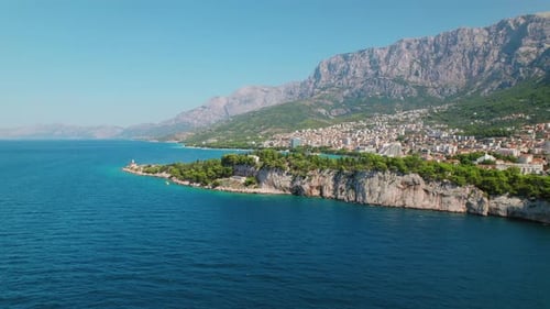 Aerial view of the city of Makarska with a church on a cape in Croatia. Summer holidays on the Adria