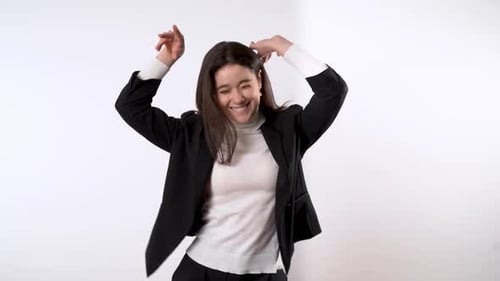 Cheerful Woman Dancing and Smiling on White Background