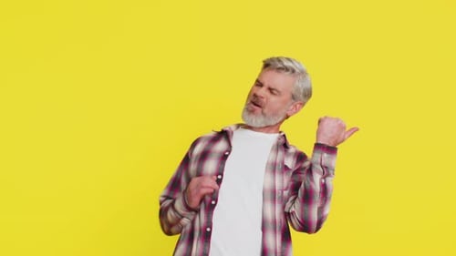 Man Dancing and Playing Air Guitar on Yellow