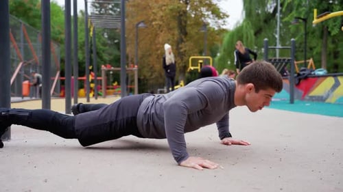 Athletic Caucasian Man in Sportswear Doing Pushup Exercise on Playground Young Bodybuilder Guy