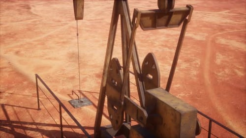 Oil Pump Jack Working in Barren Desert Landscape