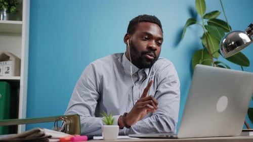Man with Beard Working on Laptop at Desk