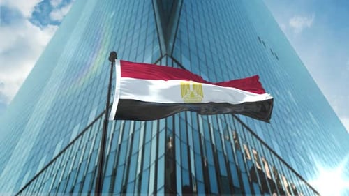 Waving Egypt Flag Against Modern Corporate Building