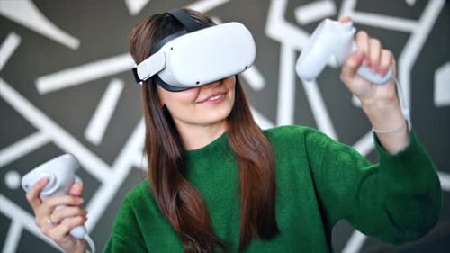 Woman Uses Virtual Reality Headset with Controllers