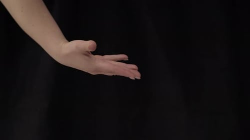 Outstretched Hand Against a Black Background