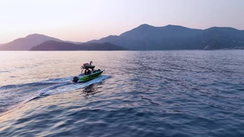 Speedboat Cruising on Ocean Waters at Sunrise