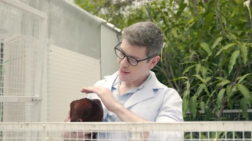 Veterinarian Holding Chicken in a Rural Setting