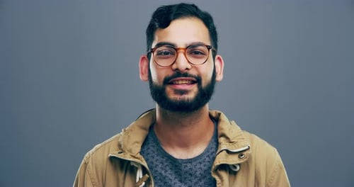 Smiling Man Makes Heart Shape with Hands