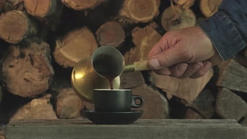 Pouring Coffee Into a Cup in Rural Setting