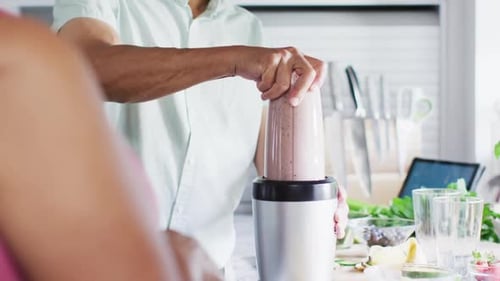Senior Man Blending Healthy Smoothie in Kitchen