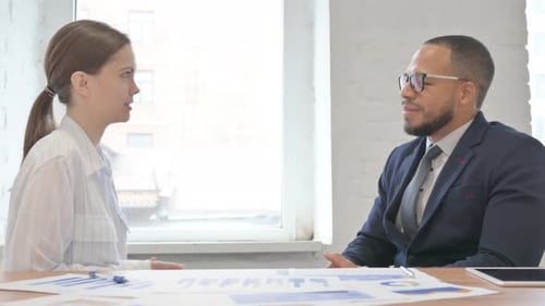 Mixed Race Teammates Talking at Work