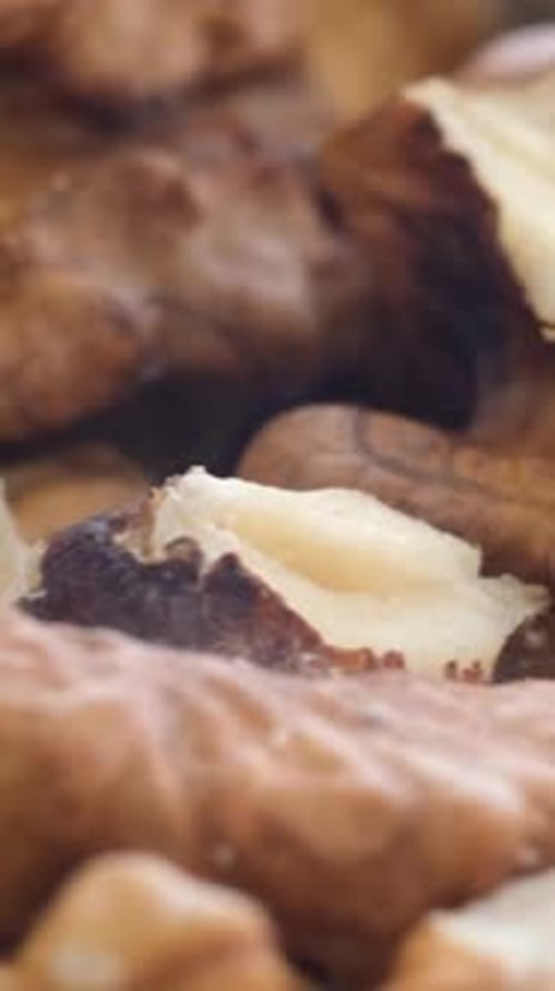 A Pile of Ripe Brown Walnuts Rotates on a Platter Useful Superfood Vertical Video