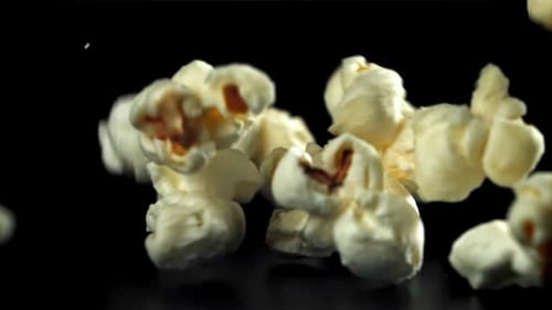 Popcorn Falls on the Table On a Black Background Filmed on a Highspeed Camera at 1000 Fps