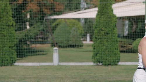 Woman Playing Tennis on Green Court