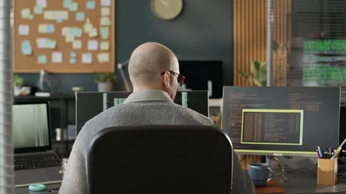 Male Software Developer Working in Empty Programmers Office