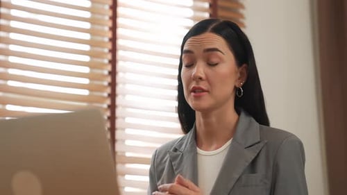Female psychologist using laptop for online video call treatment. Blithe