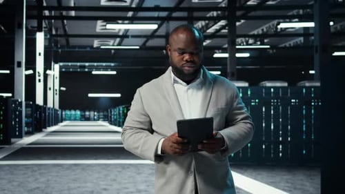 Data Center Engineer Monitoring Servers Performing AI Training