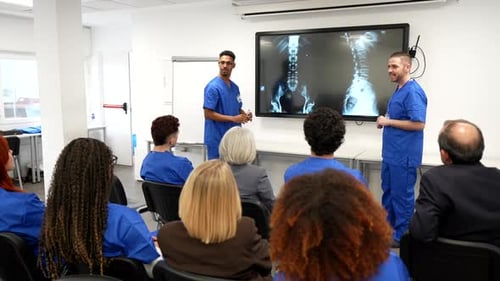 Medical Professionals Discussing X-Ray Images in Bright Office