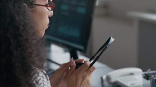 Operator Typing, Then Putting Headset on Her Head and Consulting Client