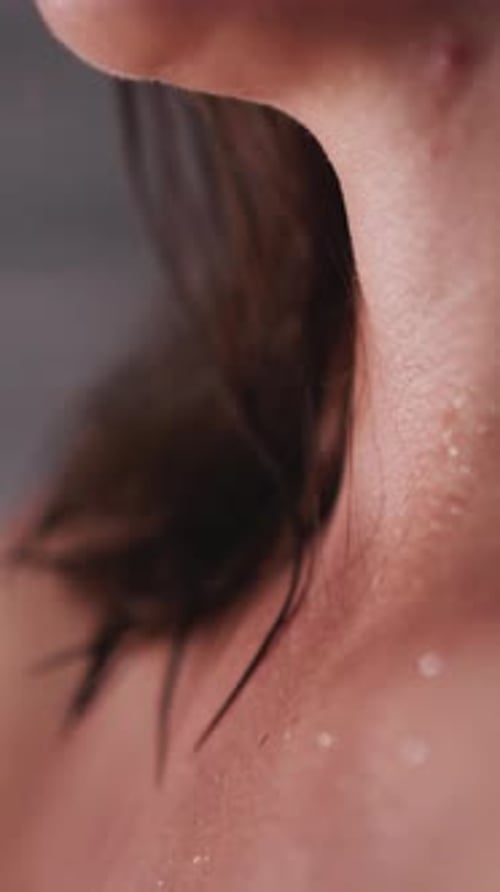 Woman's Neck with Water Droplets After Showering