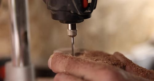 Carpenter Working on the Drill Machine in His Workshop