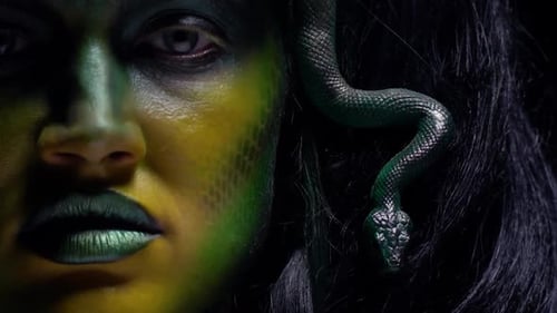 Medusa Gorgona is twitching and grinning, close up