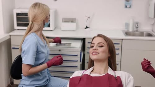 Dental Assistant Examining Patient in Modern Office