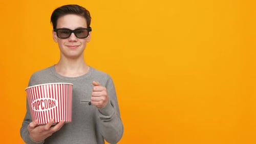 Young Person Enjoys Popcorn and Gives Thumbs Up in Bright Setting During Movie Time