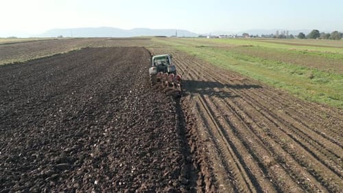 Tractor Plows Land In The Field Aerial