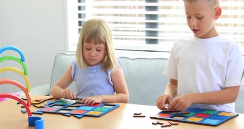Children Solving Colorful Geometric Puzzles at Table