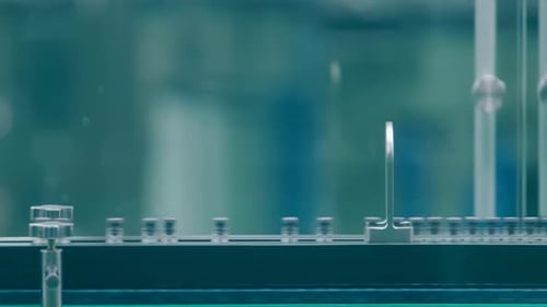 Conveyor Belt Carries Vials in Clean Manufacturing Plant