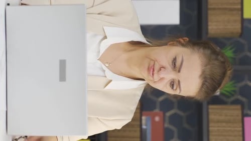 Woman Talks During Laptop Video Call in Office