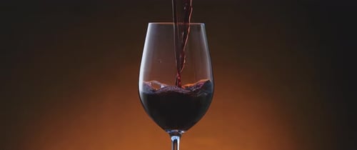 Pouring Red Wine into a Wine Glass