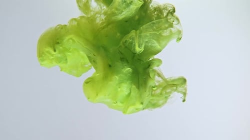 Green Ink Diffusing Abstractly in Clear Liquid