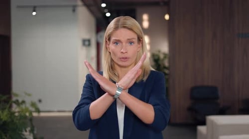 Woman Gesturing 'No' in Office Setting