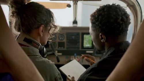 Pilots Discussing Navigation Screen during Flight Training Session