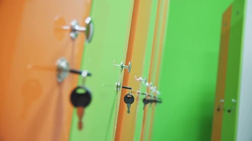 Green and Orange Cabins Doors in Empty Gym Locker Room