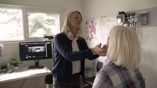 Female Doctor Examining Senior Patient in Clinic Examination Room Adult
