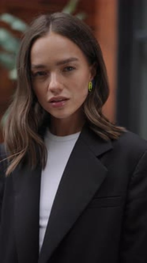 Fashionable Woman Poses Wearing Black Blazer and Earrings