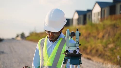 Surveyor Using Theodolite for Road Construction Measurement