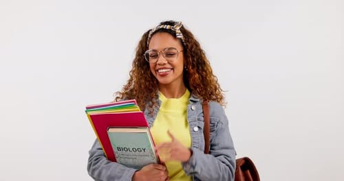 Student woman, books and face in studio, smile and glasses for learning