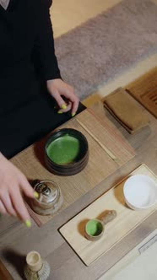 Preparing Green Matcha Tea with Bamboo Whisk