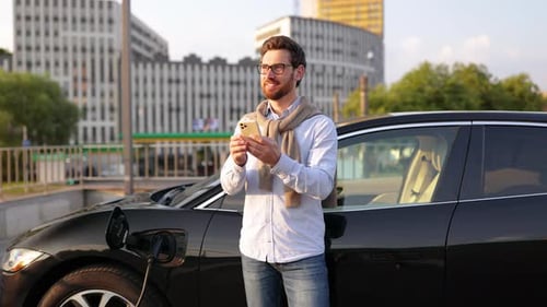 Man Charging Electric Vehicle