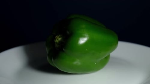 Spinning around revealing this healthy Green Bell Pepper ready to be sliced to add in a salad.