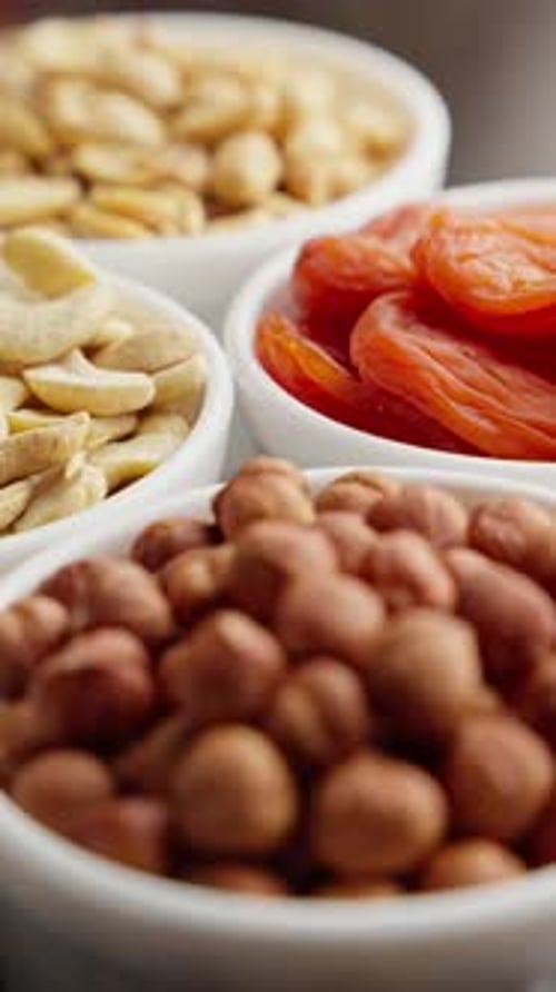 Vibrant Display of Almonds Cashews Walnuts and Dried Apricots Fills Bowls