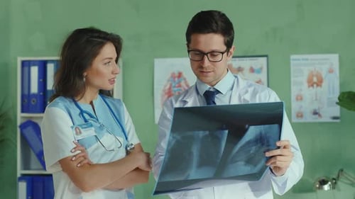 Doctors Reviewing X-Ray Image in Medical Office
