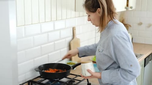 Close Up of a Woman Chopping Vegetables in a Kitchen Female Hands Cutting Tomato Carrot on the Board