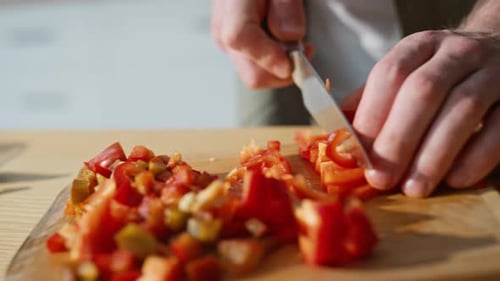 Hands Dicing Red Bell Pepper on Cutting Board