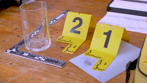 Yellow evidence markers with fingerprints and glass. Demonstration with ...